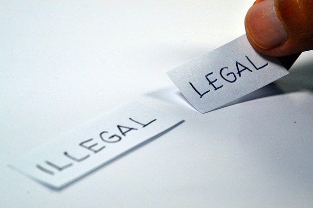 illegal legal written on two scraps of paper