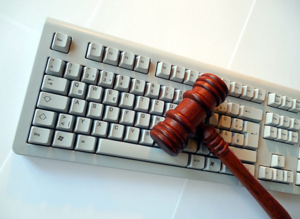 keyboard on white background with gavel on top