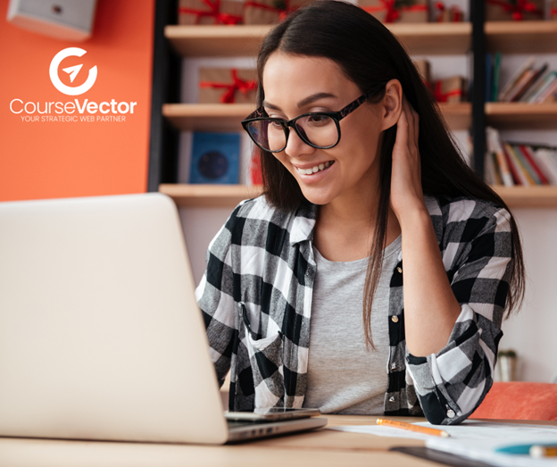 woman working at a laptop with coursevector logo behind her